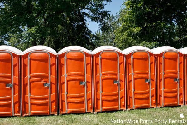 a lineup of clean and well-maintained portable loos for workers in Owyhee, NV